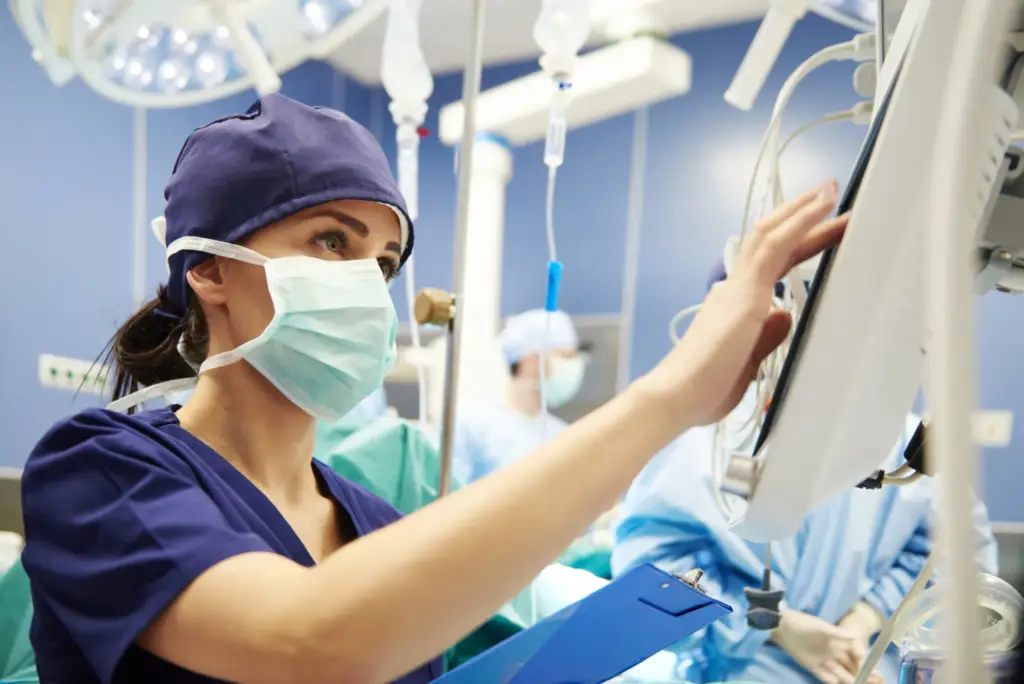 Surgeon reviewing medical images in operating room.