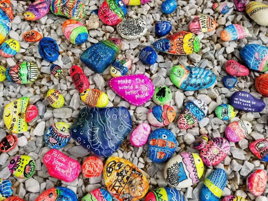 Colorful painted rocks with positive messages and designs.