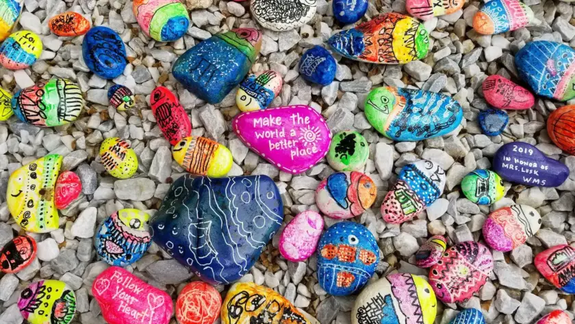 Colorful painted rocks with positive messages and designs.