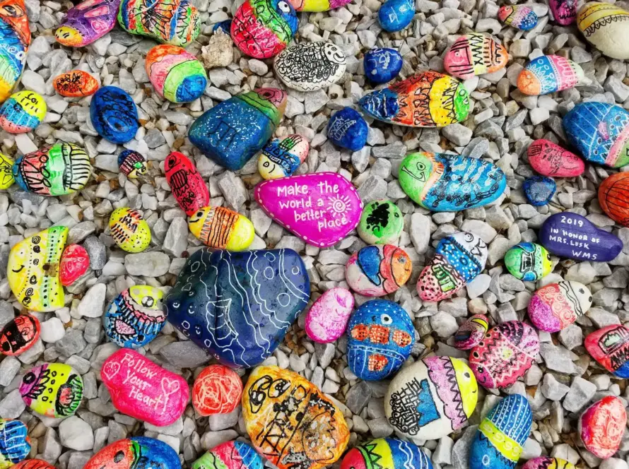 Colorful painted rocks with positive messages and designs.