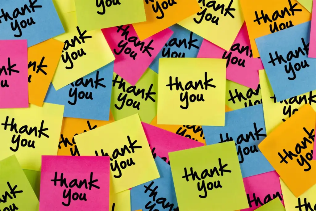 Colorful sticky notes with 'thank you' written on them scattered randomly.