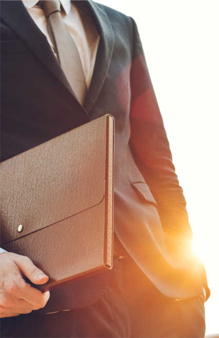 Business attorney in Phoenix, Arizona holding a briefcase.