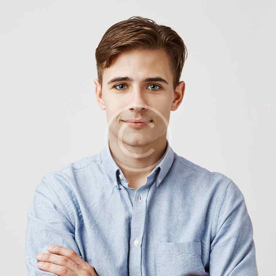 Young man with light brown hair in a blue shirt.