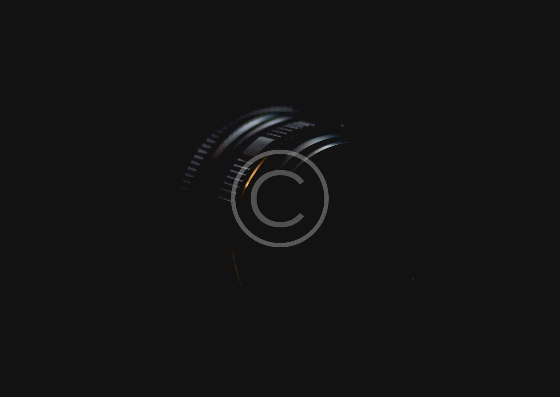 Abstract black and white spiral design with a copyright symbol.