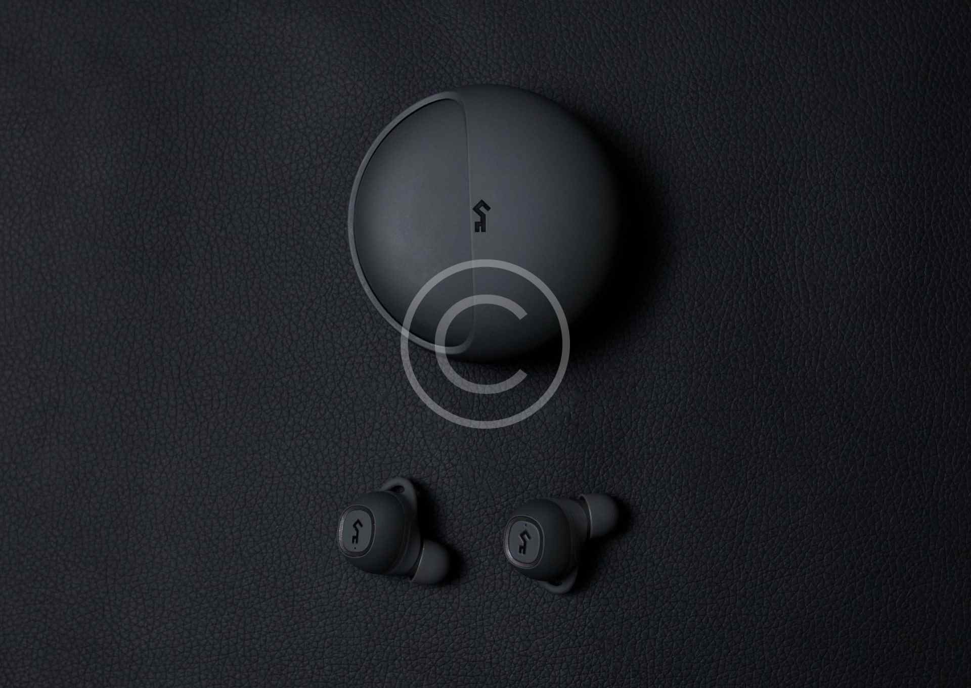 Black wireless earbuds with charging case on a dark background.