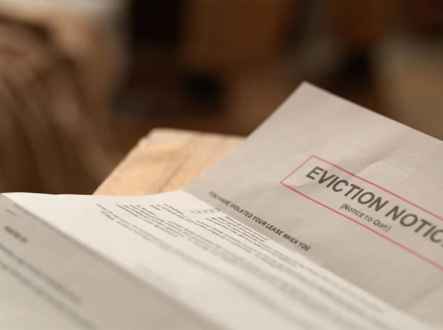 Close-up of an eviction notice letter on a wooden surface.