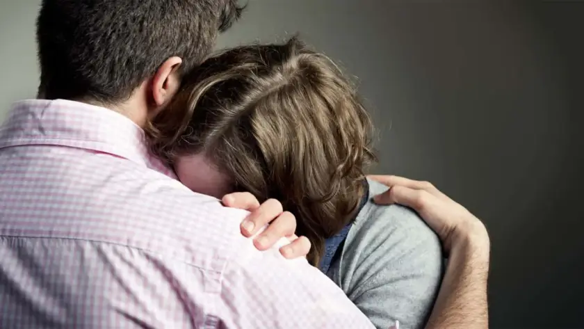 Two people embracing in a comforting hug.