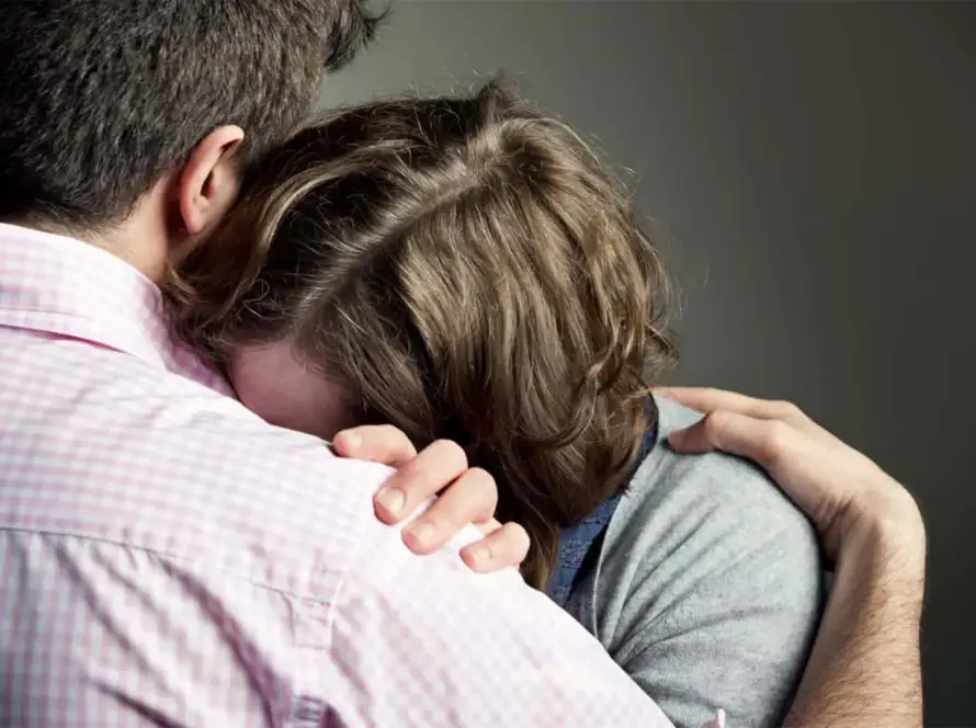 Two people embracing in a comforting hug.