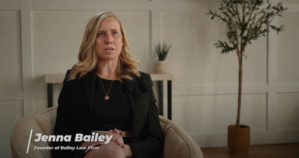 Woman speaking in an interview setting with text overlay of her name.