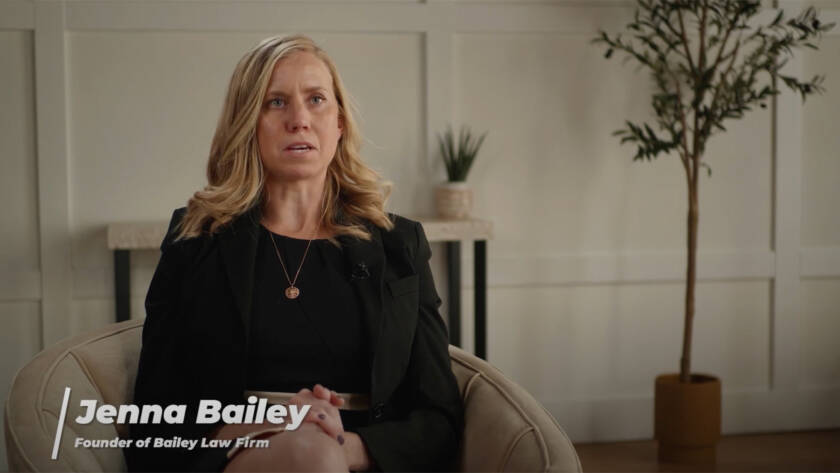 Woman speaking in an interview setting with text overlay of her name.