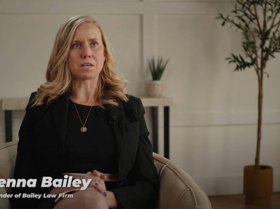 Woman speaking in an interview setting with text overlay of her name.