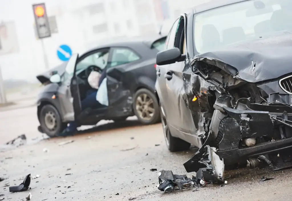 Two cars with severe front-end damage after a collision.