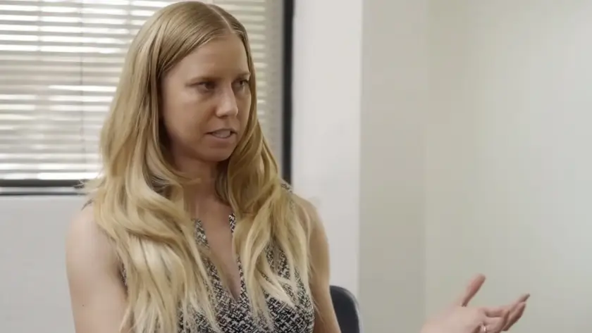 Woman with long blonde hair looking skeptically to the side.