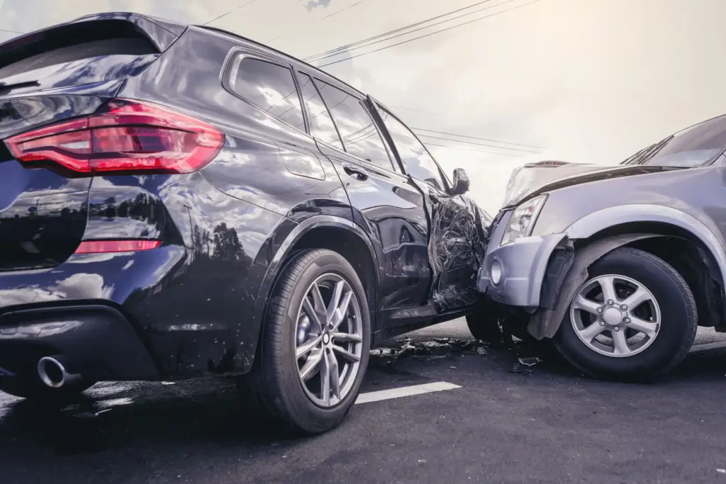 Two cars damaged in a side collision accident in a parking lot.