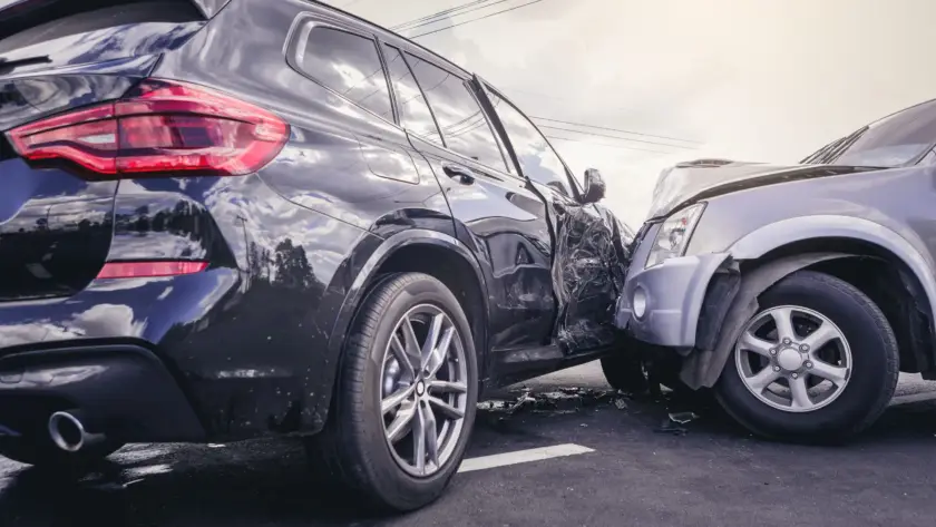 Two cars damaged in a side collision accident in a parking lot.