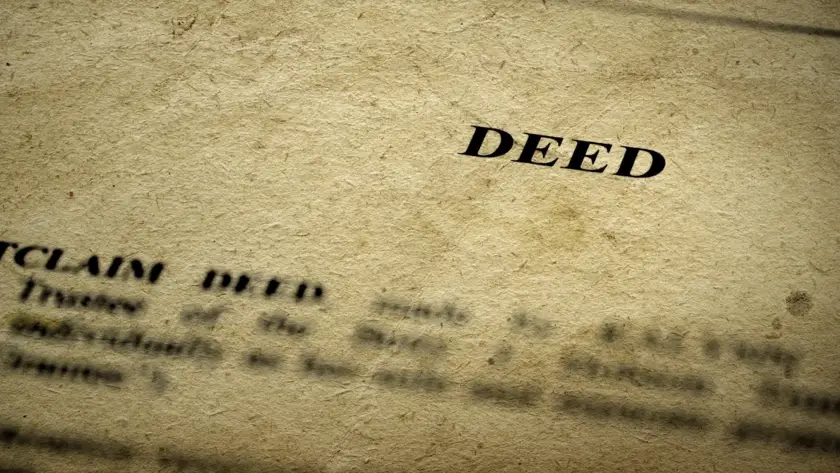 Close-up of a legal deed document on textured paper.