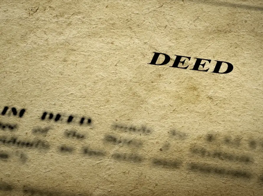 Close-up of a legal deed document on textured paper.