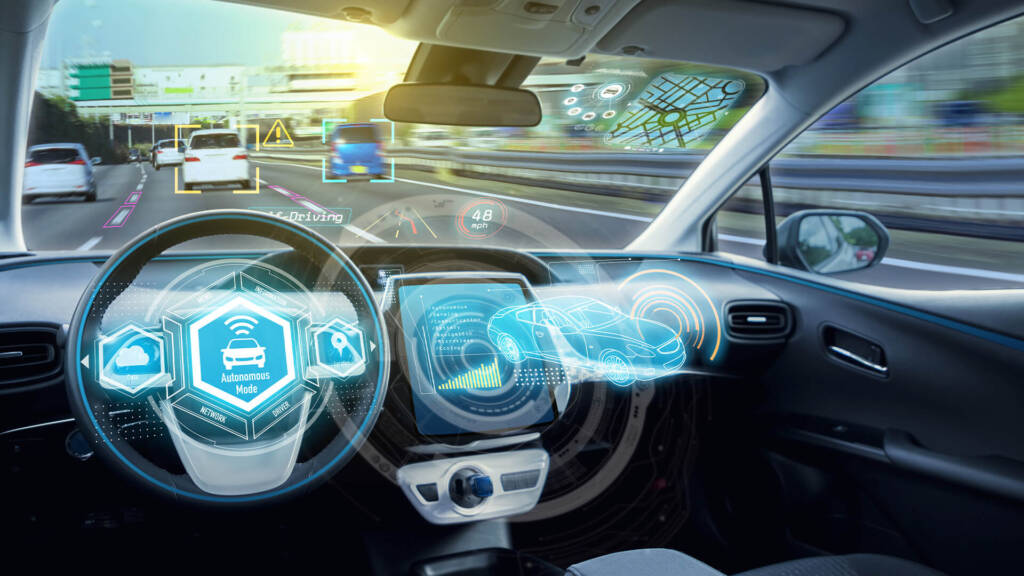 Futuristic car interior with holographic dashboard displays.