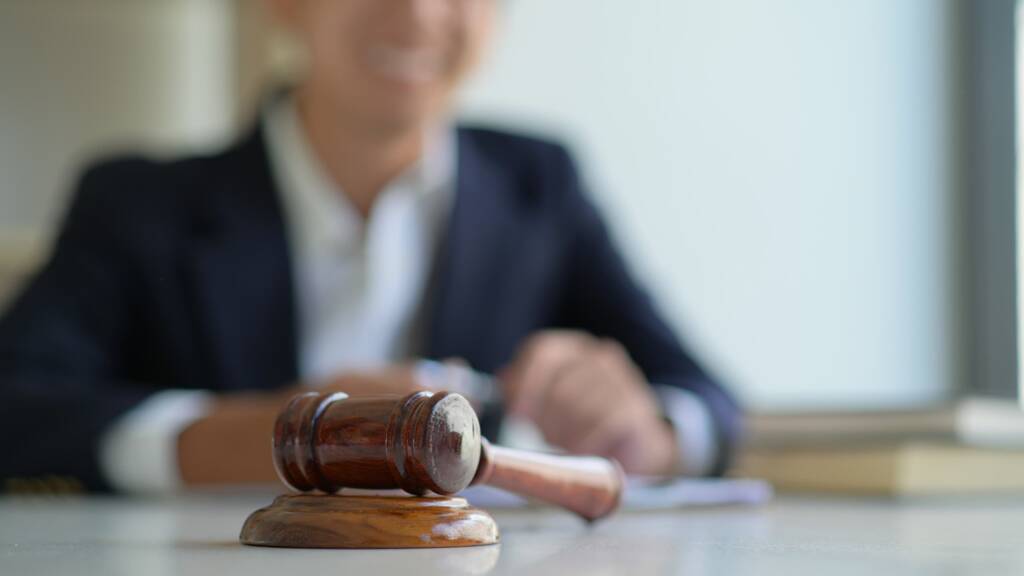 Judge in the courtroom with a gavel.