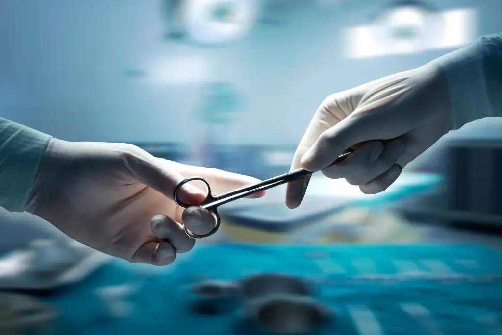 Surgeons exchanging a surgical instrument during an operation.