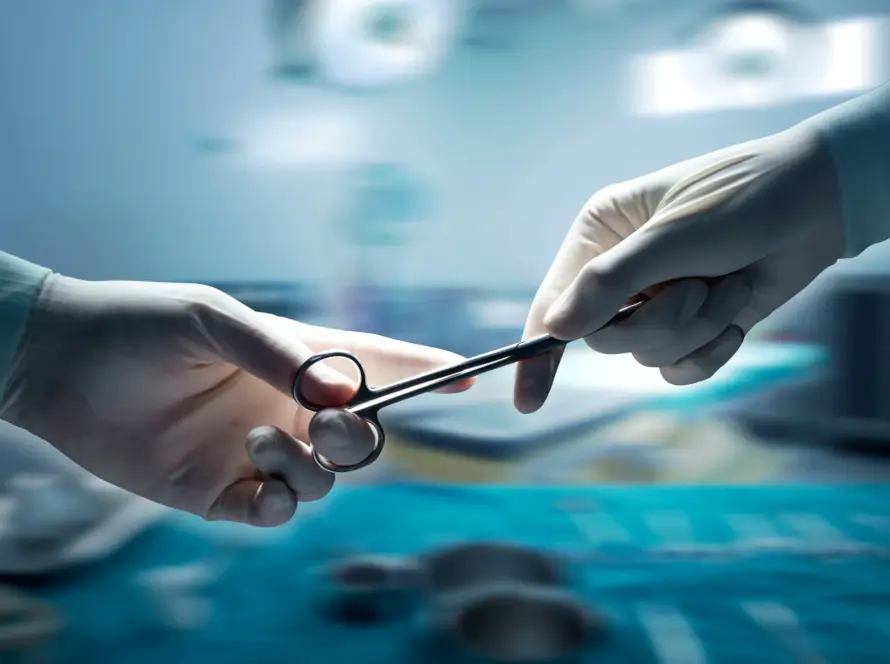 Surgeons exchanging a surgical instrument during an operation.