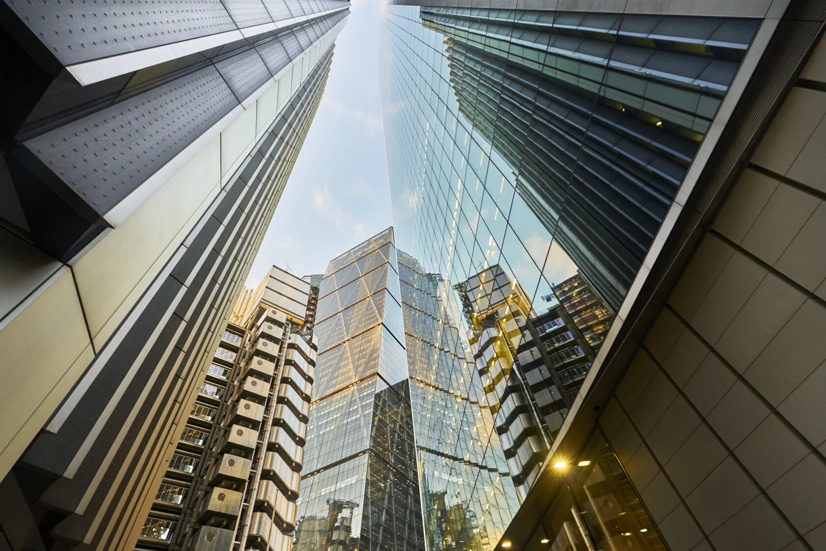 Modern glass skyscrapers towering against the sky in a city.