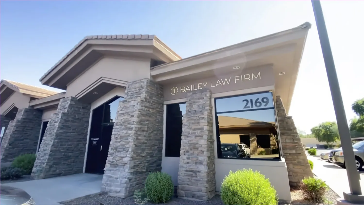 Exterior of a modern building with stone accents and address 2169.