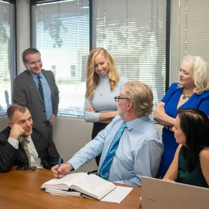 Business meeting with engaged team discussing ideas around a table. Business meeting with engaged team discussing ideas around a table.